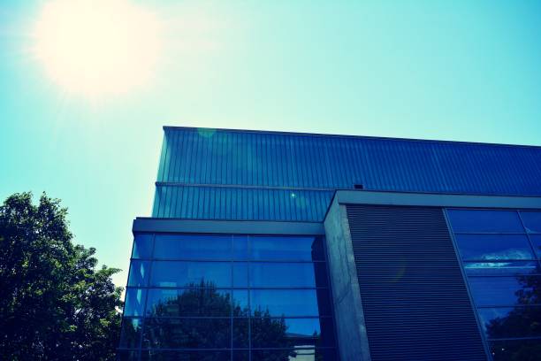 istock Modern office building on a clear sky background. Retro stylized colorful tonal filter effect 1021220600