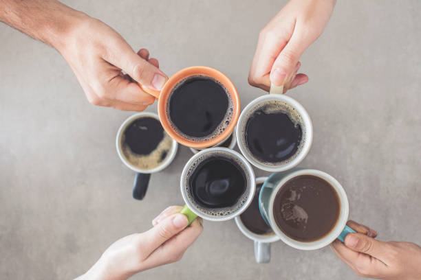 istock People hands holding cups of coffee 1021240770