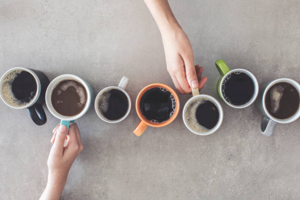 istock People hands holding cups of coffee 1021240774