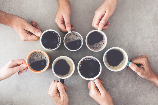 People hands holding cups of coffee