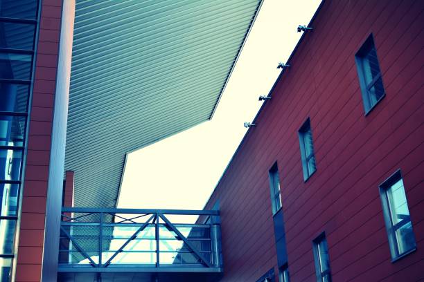 istock Modern office building on a clear sky background. Retro stylized colorful tonal filter effect 1021251792