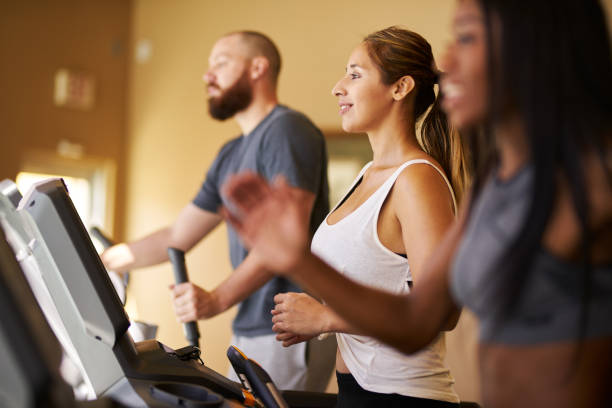 istock people using treadmills in busy gym working out 1021265350