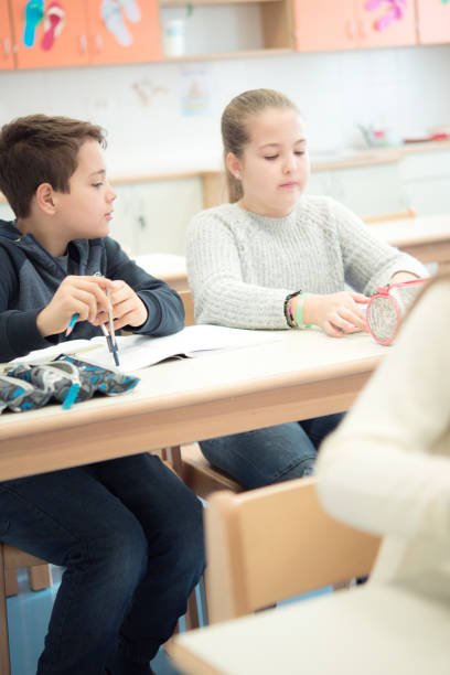 istock School Children Sitting in the Classroom During Lessons 1021273136