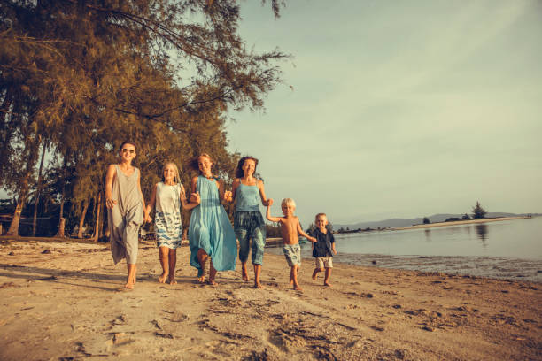 istock Friends playing in waves on beach 1021275786