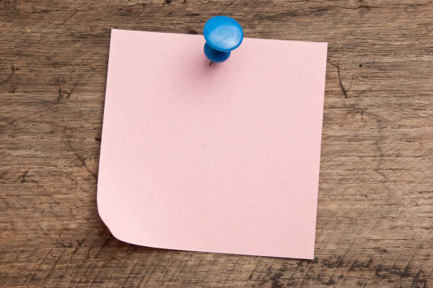 Blank pink sticky note on desktop. Business reminder and to-do planning place for text