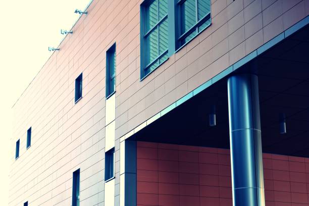 istock Modern office building on a clear sky background. Retro stylized colorful tonal filter effect 1021276636