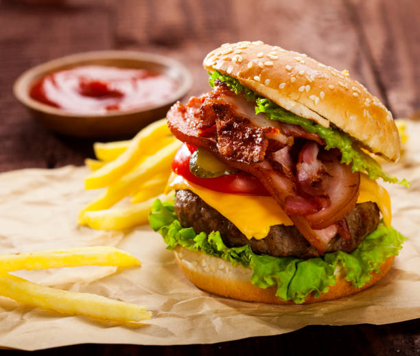istock Fresh delicious burger on a wooden background 1021284438
