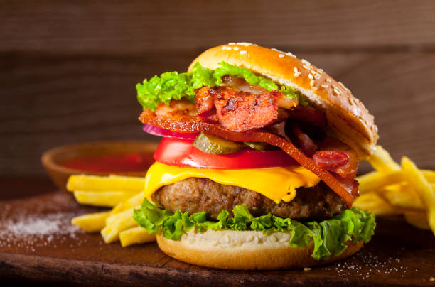 istock Fresh delicious burger on a wooden background 1021284498