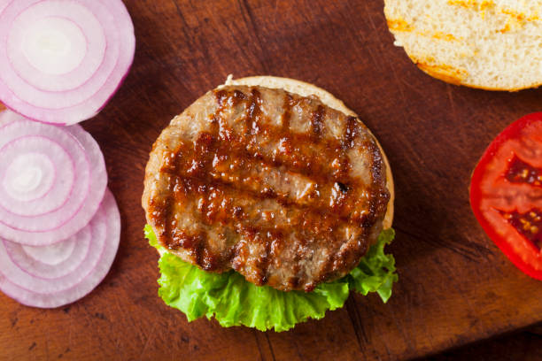 istock Fresh delicious burger ingredients on a wooden background 1021284512