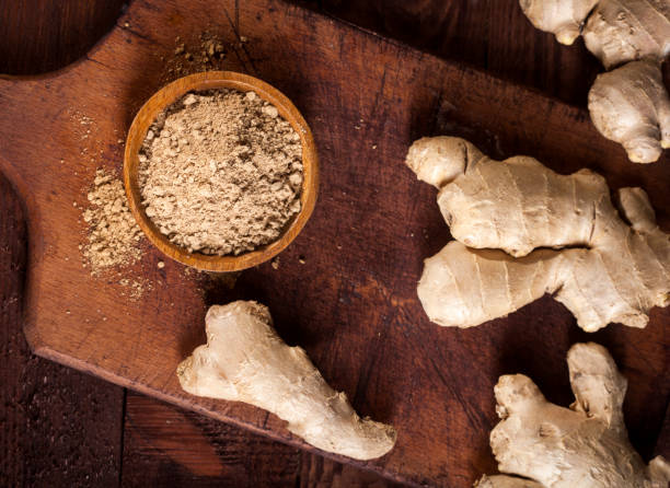 istock Ginger root and ginger powder on wooden background 1021301392