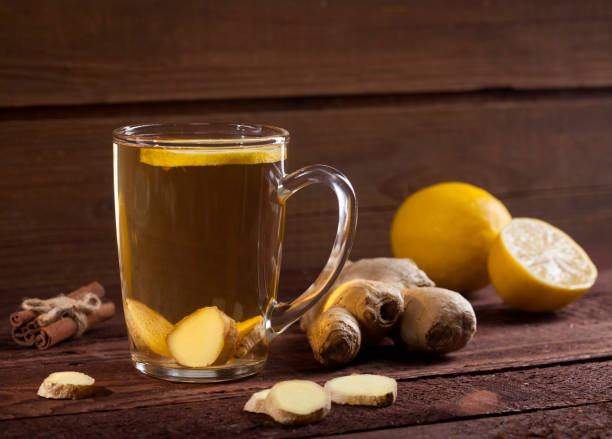 istock Ginger tea with lemon on wooden background 1021301402