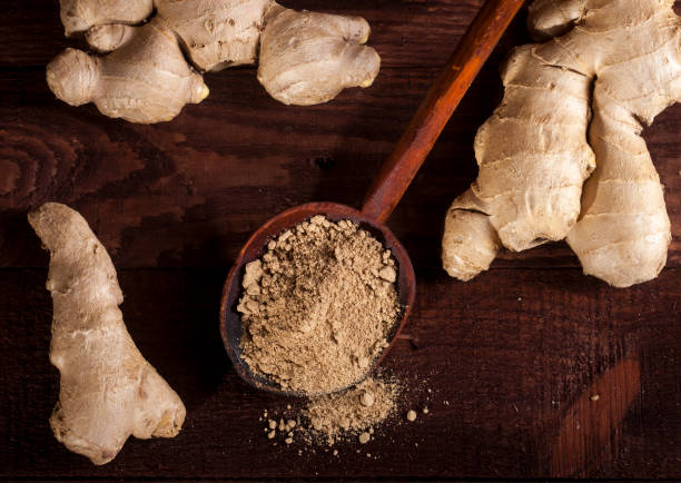istock Ginger root and ginger powder on wooden background 1021301418