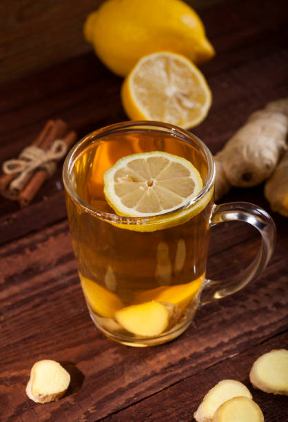istock Ginger tea with lemon on wooden background 1021301430