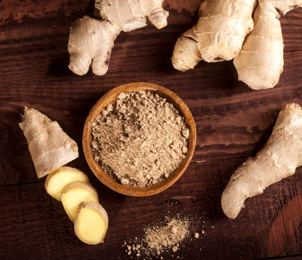 istock Ginger root and ginger powder on wooden background 1021301452