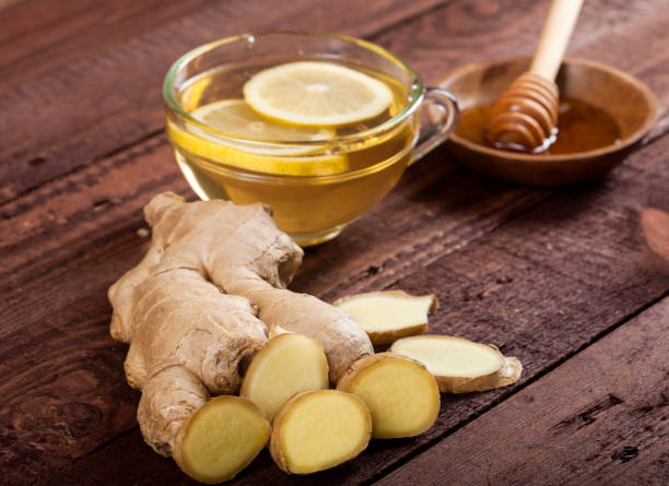 istock Ginger tea with lemon on wooden background 1021301466