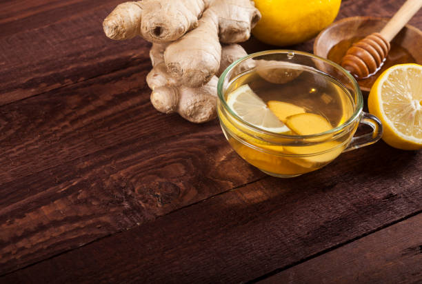 istock Ginger tea with lemon on wooden background 1021301480