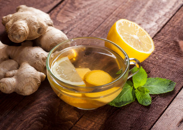 istock Ginger tea with lemon, mint and honey on wooden background 1021301486