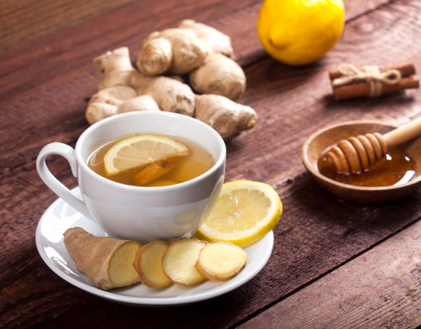 istock Ginger tea with lemon, cinnamon and honey on wooden background 1021301496