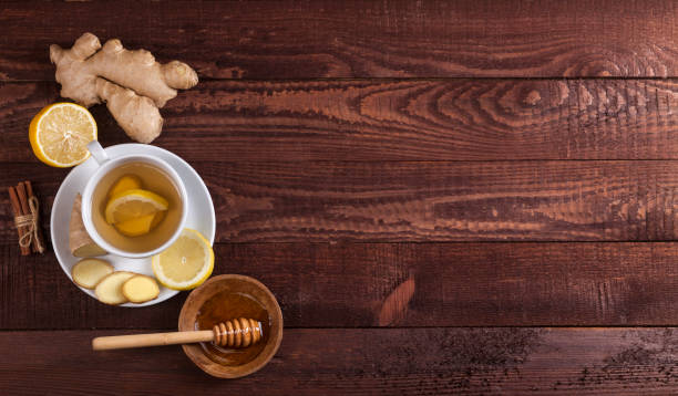 istock Ginger tea with lemon, cinnamon and honey on wooden background 1021301508