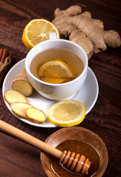 istock Ginger tea with lemon, cinnamon and honey on wooden background 1021301514