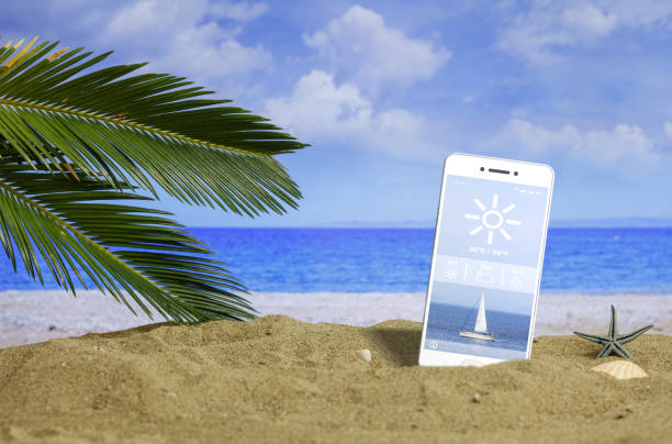 Summer vacations - Smartphone with weather app on a sandy beach. 3d illustration