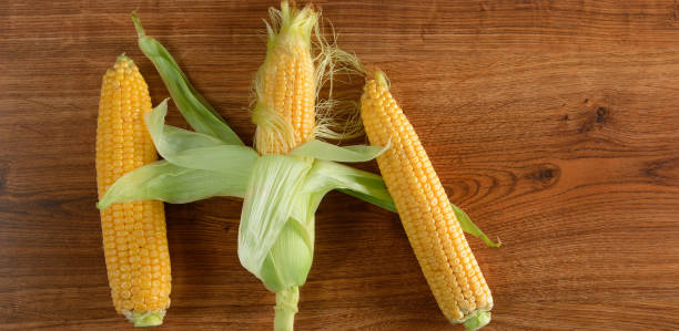 istock Three fresh corn cob on wooden table. Healthy food. 1021307064