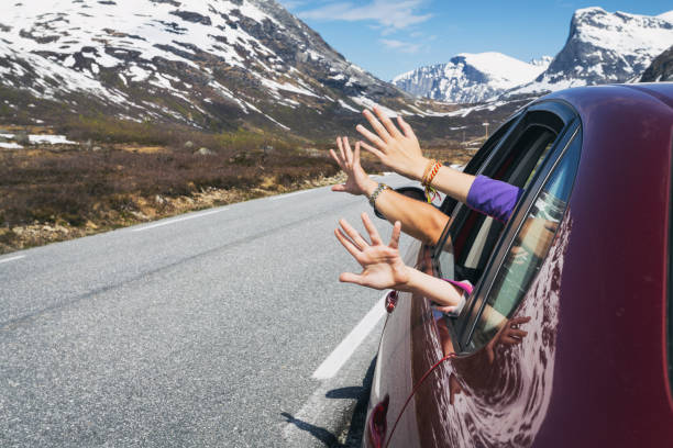 happy trip happy trip - hands of men and children peering out of the car on a background of mountains"n northern europe family car stock pictures, royalty-free photos & images