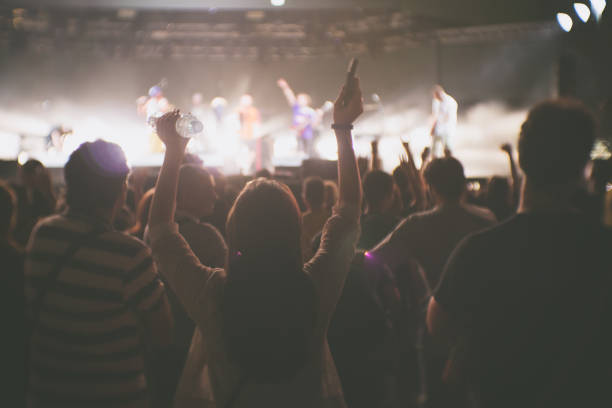 istock Young woman raising hands during the concert 1021312866