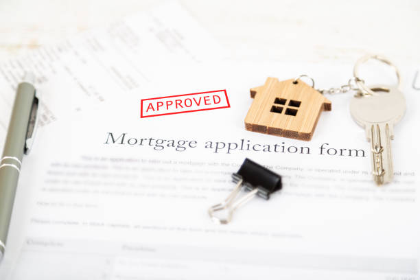 istock Approved mortgage loan agreement application with house shaped keyring 1021313462