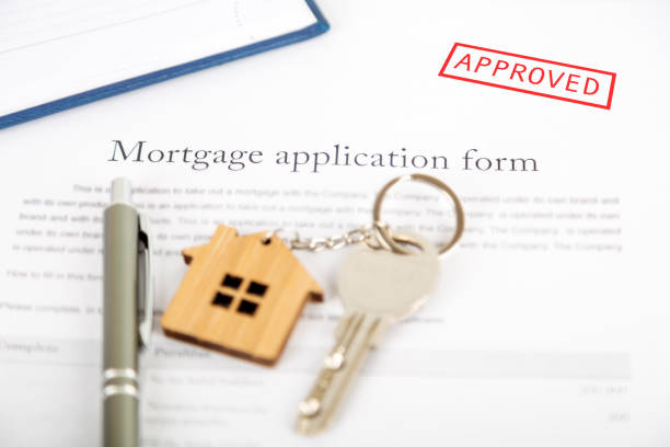 istock Approved mortgage loan agreement application with house shaped keyring 1021313486
