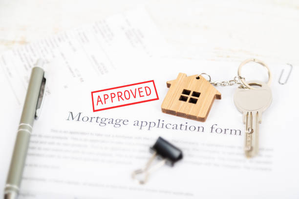 istock Approved mortgage loan agreement application with house shaped keyring 1021313526