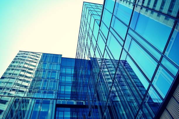 istock Modern office building on a clear sky background. Retro stylized colorful tonal filter effect 1021320470