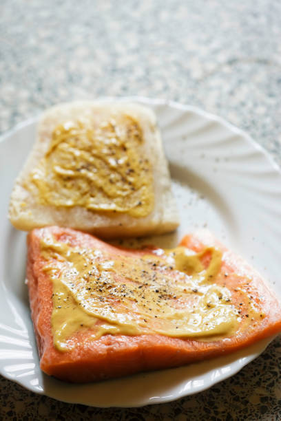 istock Oven ready raw halibut and salmon fillets with mustard 1021320576