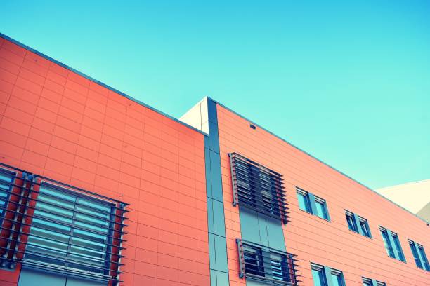 istock Modern office building on a clear sky background. Retro stylized colorful tonal filter effect 1021320902