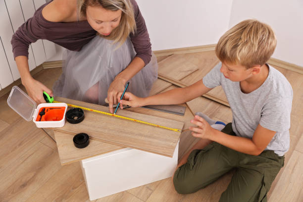 istock Modern single mom concept , mother and son measuring a board in carpentry, doing diy project, spending quality time together 1021323110