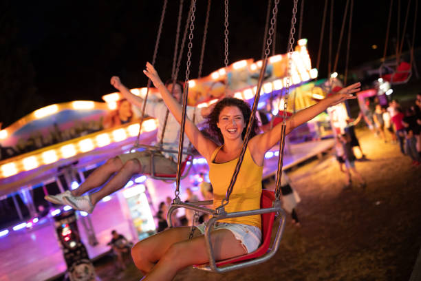 istock Happy young couple on carousel in amusement park 1021328456