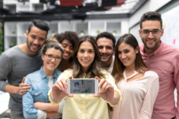 istock Happy group of designers taking a selfie at a creative office 1021336858