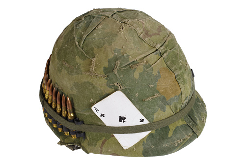 US Army helmet Vietnam war period with camouflage cover and ammo belt and amulet - the ace of spades playing card