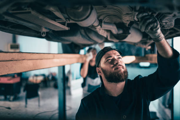 istock Garage Mechanics Working On Repairing A Car 1021340074
