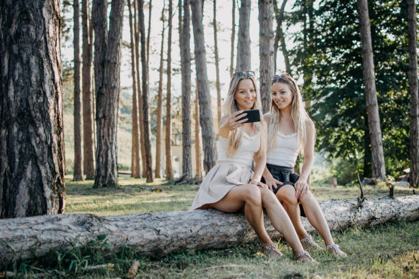 istock Twin sisters are walking in the park 1021341134