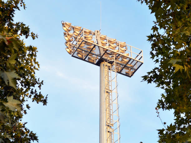 istock Sport lighting mast with powerful searchlights between trees 1021347788