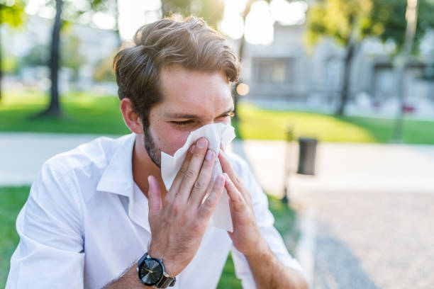 istock Man with handkerchief sneezes. 1021350806