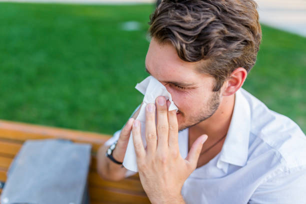 istock Young man struggling with allergies in the park on a bright spring day 1021351232