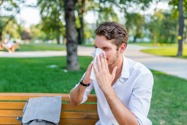 istock Man with handkerchief sneezes 1021351240