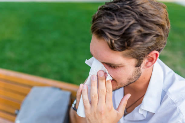 istock Man with allergy or an infection sneezing 1021351456