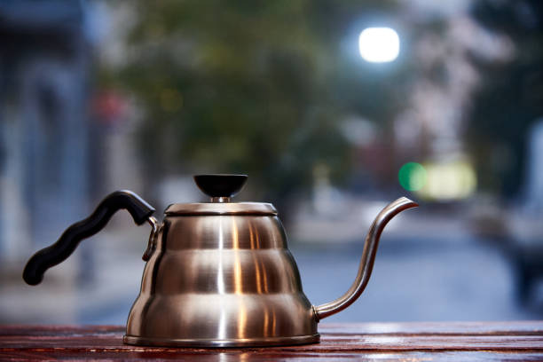 The kettle stands on a wooden surface in a blurred background