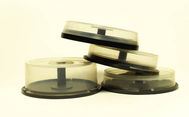 istock storages with spindel for compact disc. small capasity boxes with transparent covers, stacked in pile 1021362246