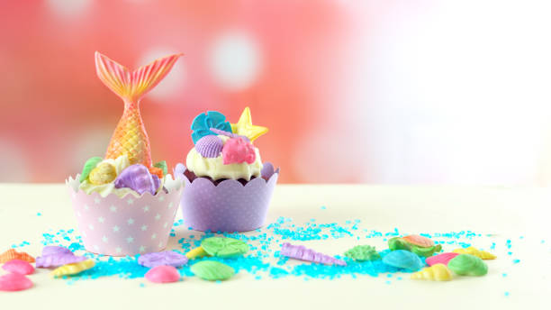 Mermaid theme cupcakes with colorful glitter tails, shells and sea creatures toppers for children's, teen's, novelty birthday and party celebrations.