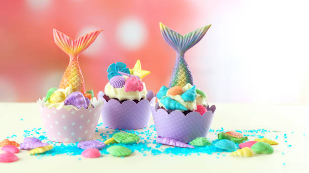 istock Mermaid theme cupcakes with colorful glitter tails, shells and sea creatures 1021362508
