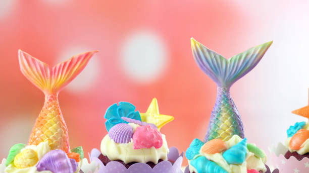 istock Mermaid theme cupcakes with colorful glitter tails, shells and sea creatures 1021365166